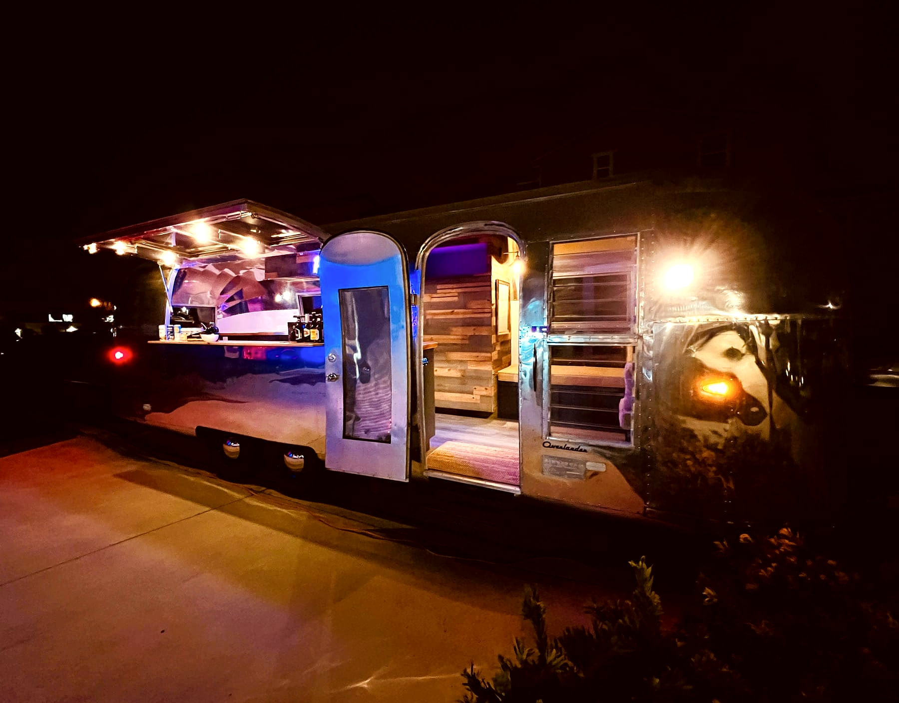 Park & Craft restored Airstream mobile bar lit up at night